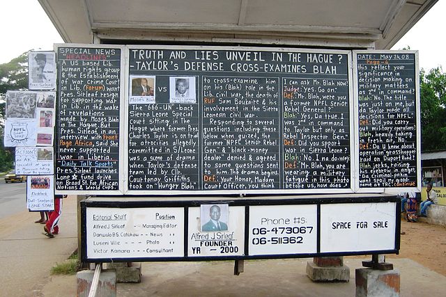 A daily news chalk board in Monrovia, Liberia. Photo by Lieutenant Colonel Terry VandenDolder, U.S. Africa Command. Public domain via Wikimedia Commons.