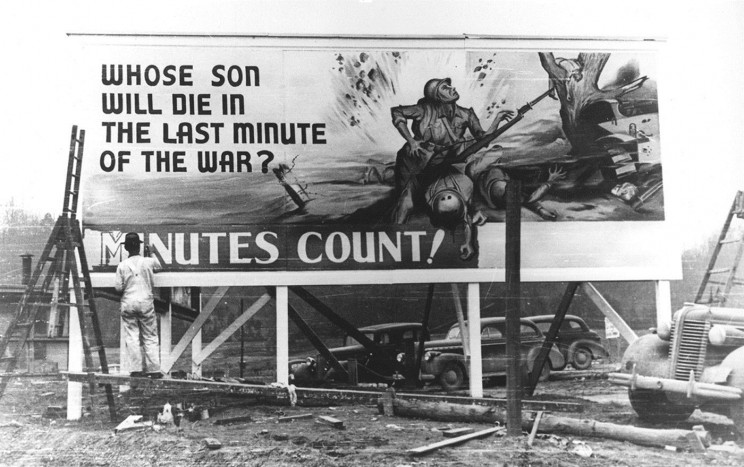 The poster refers to the deployment of the atomic bombs in anticipation of the expected huge sacrifices of the invasion of Japan in 1945. Photograph of the legendary Ed Westcott; the image is in public domain, courtesy of Oak Ridge National Laboratory.