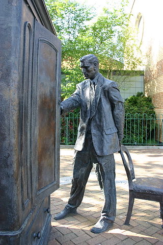 Statue of C.S. Lewis looking into a wardrobe. Entitled "The Searcher" by Ross Wilson. Photo credit: "Genvessel", Creative Commons via Flickr.