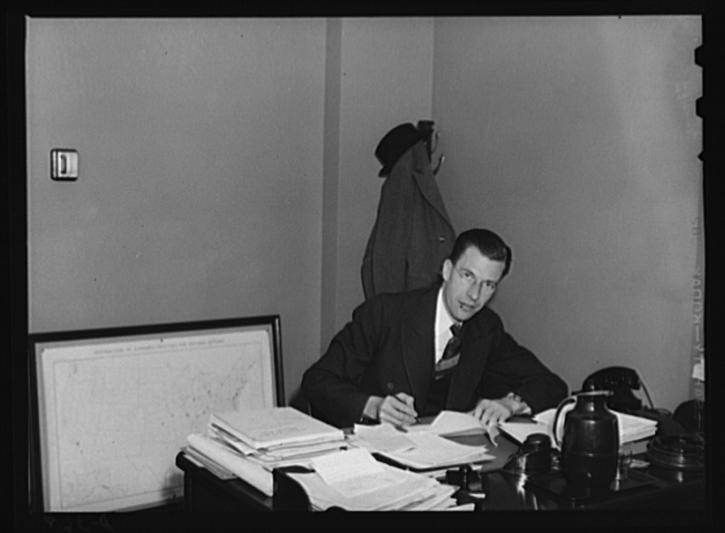 Dr. John Kenneth Gailbraith, assistant administrator, Office of Price Administration (OPA) and Civilian Supply, Office of Emergency Management. Dr. Galbraith is an assistant professor of economics at Princeton University. Dixon, Royden, photographer. Office of War Information. Library of Congress Prints & Photographs Division