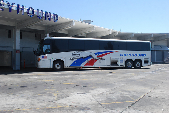 Greyhound lines # 7170, a MCI G4500, waits for passengers in back of the Oakland, CA Greyhound terminal. Taken by a Nikon D40x with a Nikon 18-55mm non-VR kit lens. (at 26). Photo by Paul Sullivan. Creative Commons License via Paul Sullivan Flickr.