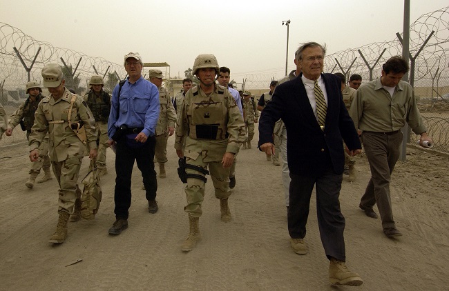Secretary of Defense Donald H. Rumsfeld takes a tour of the Abu Ghraib Detention Center in Abu Ghraib, Iraq, on May 13, 2004. Rumsfeld and Chairman of the Joint Chiefs of Staff Gen. Richard B. Myers are in Iraq to visit the troops in Baghdad and Abu Ghraib.   DoD photo by Tech. Sgt. Jerry Morrison Jr., U.S. Air Force. Public domain via defense.gov. 