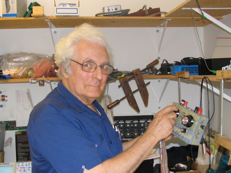 Synthesizer pioneer Bob Moog poses with an unknown device in the Moog Music office in July 2004.