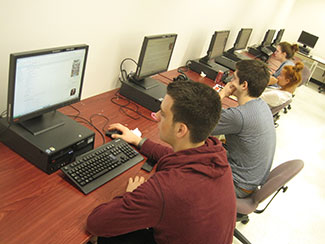 Work in the computer lab by MCPearson CC-BY-SA-3.0 via Wikimedia Commons.