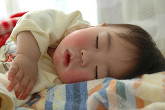 Sleeping baby by Minoru Nitta. CC BY 2.0 via Flickr.