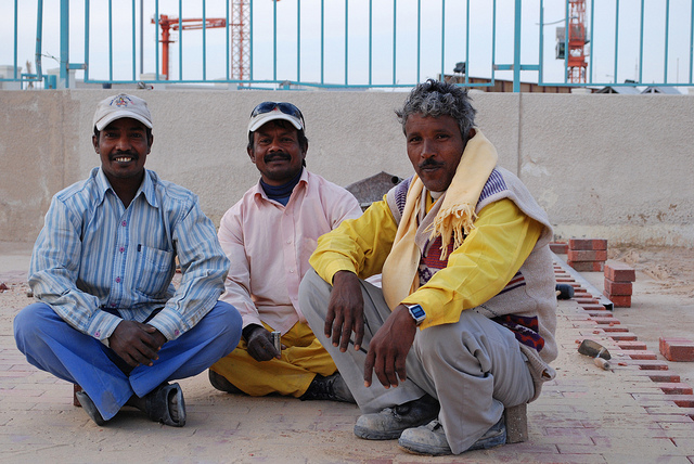 Builders at Work: There are close to one million migrant workers in Qatar, mainly from South Asia. The majority work in construction. Photo by WBUR Boston's NPR News Station. CC BY-NC-ND 2.0 via wbur Flickr. 
