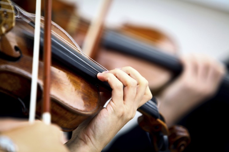 Detail of violin being played by a musician. © bizoo_n via iStockphoto.
