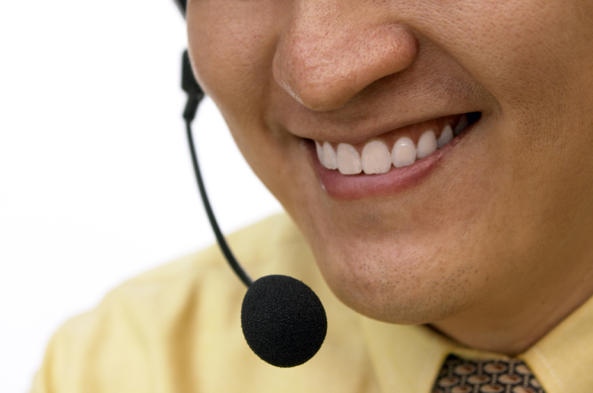 Close up of a man smiling  on the line through a headset. © cenix via iStockphoto.