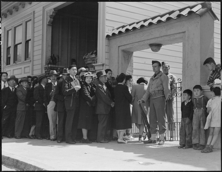 Japanese family heads and persons living alone, form a line outside Civil Control Station located in the Japanese American Citizens League Auditorium at 2031 Bush Street, to appear for 