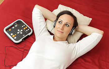 Photo of woman listening to audiobook