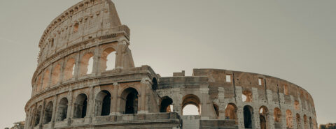 The Colosseum in Rome under grey skies during the day time