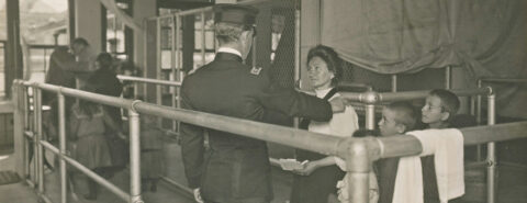 Immigrants at Ellis Island undergoing a medical inspection, grey scale image