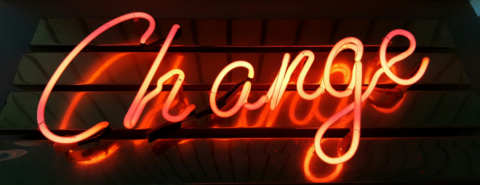 Image of a red neon sign that reads "Change"