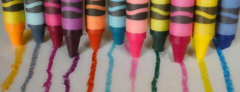 A group of crayons lined up in a row