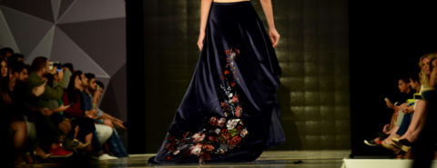 Close up of the lower part of a dress of a model walking a fashion show runway