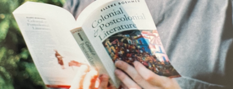 Close up of Elleke Boehmer holding a copy of the first edition of Colonial and Postcolonial Literature in 1995.