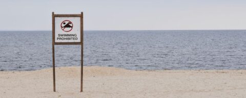 Beach with a sign that reads "Swimming Prohibited"